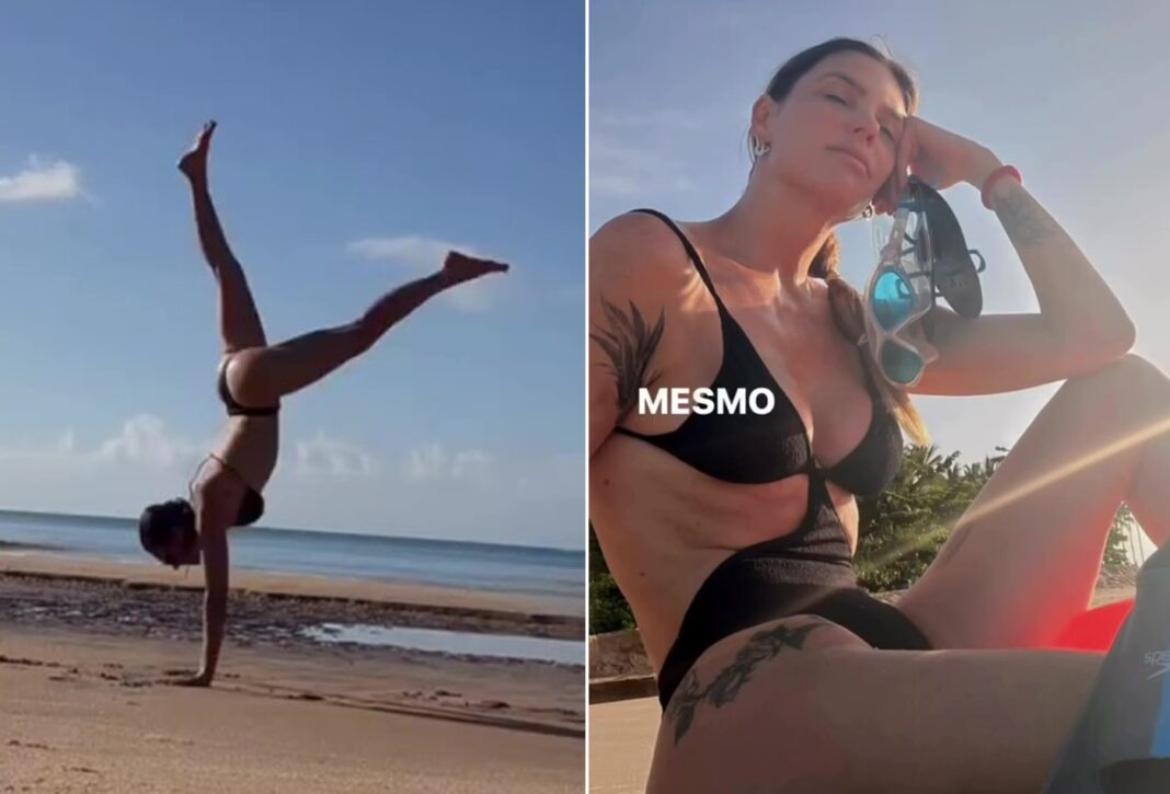 De maiô, Fernanda Lima medita e faz acrobacias em praia isolada; assista